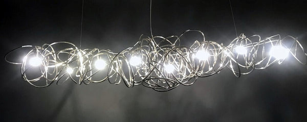 Lights of Scandinavia - Ball of Yarn - Breathtaking art deco lighting.  Bent aluminum framework in 4 color variants, equipped with multiple E17 light sources. This chandelier will make the most of your living room area, add style to a conference room or act as the perfect icebreaker for the reception.   Each Ball of Yarn is handmade so allow for slight differences between the photos and your finished product.